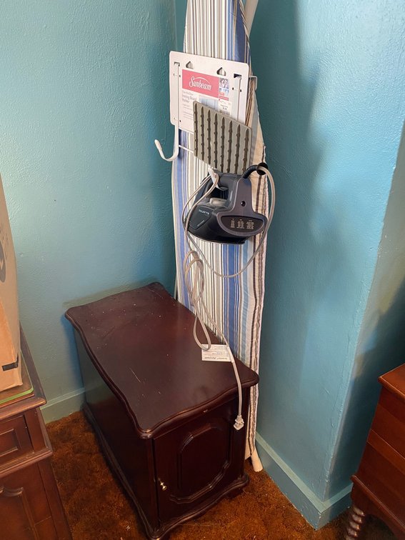 Rowenta iron, ironing board, small side cabinet