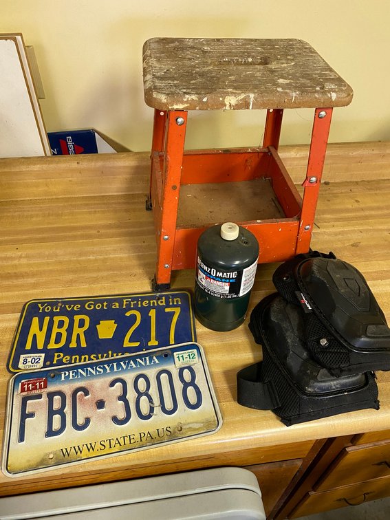 2 Pennsylvania license plates, small stool, propane bottle, knee pads