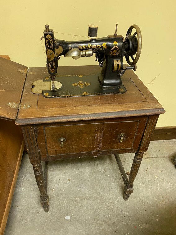 White rotary sewing machine with cabinet**veneer is peeling and chipping**