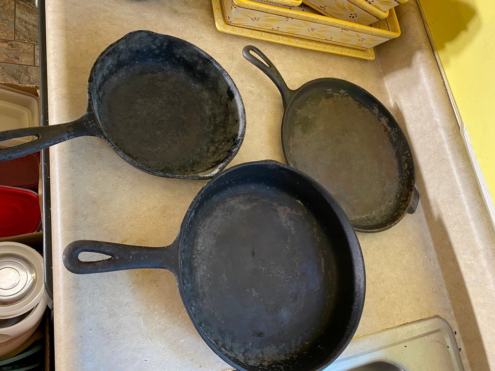 2 Cast iron skillets, cast iron griddle-no names