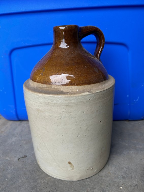 Cream and brown jug with chip on outer rim