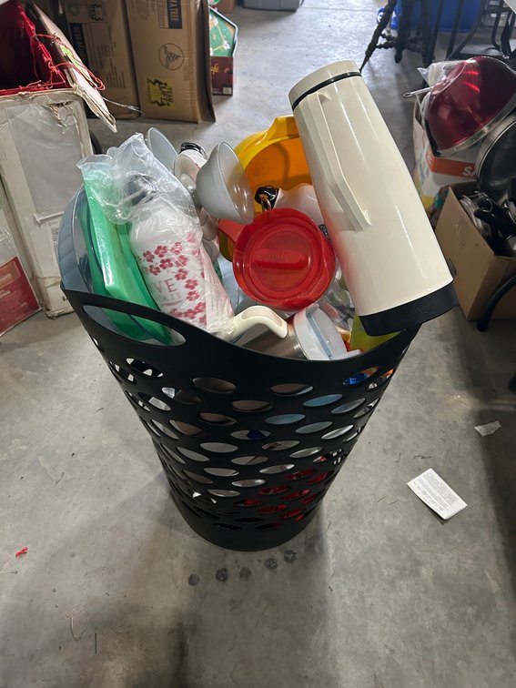 Tupperware pieces and other storage items in brown basket