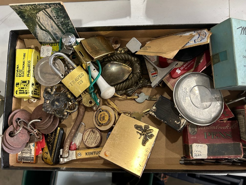 Assorted items: lock, cigarrette case, bottle opener, ECG tube, etc