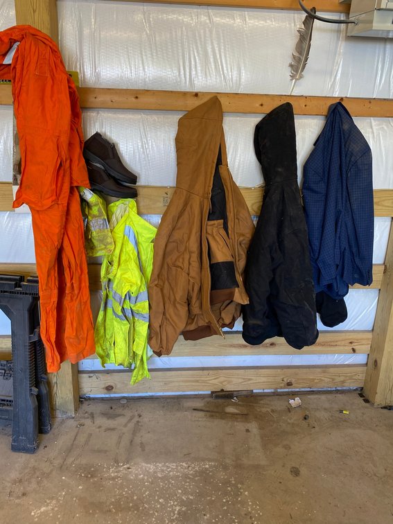 Assortment of coats, rainsuit, coveralls, pair of shoes, reflective bibs
