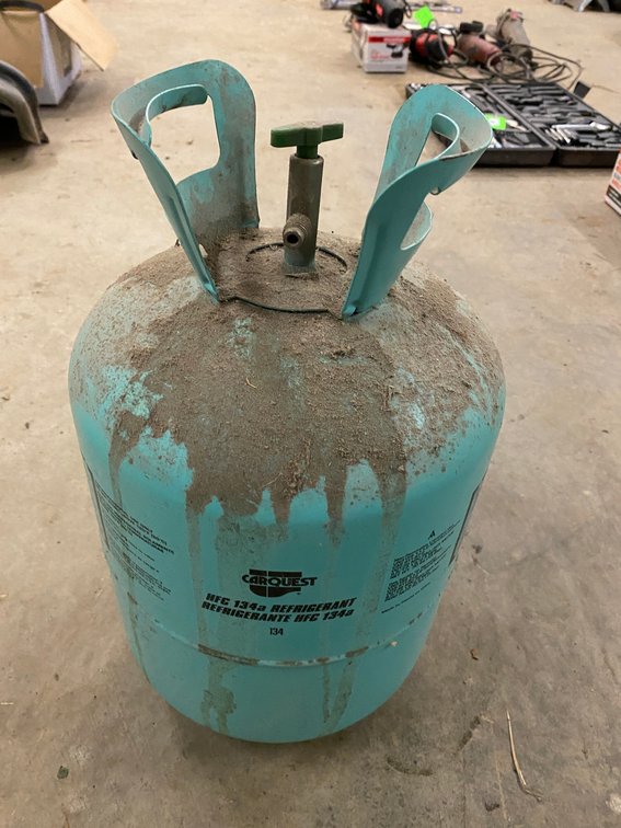 Partial bottle of Car Quest air conditioning gas-134A