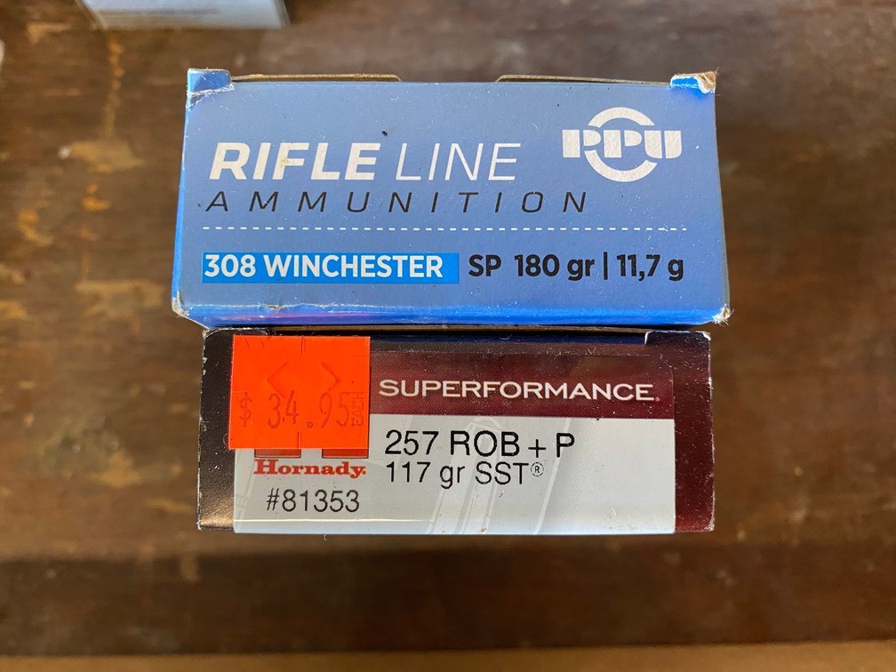 2 Boxes of shells-1 has 308 Winchester 180 grain, other has 257 ROB 117 grain