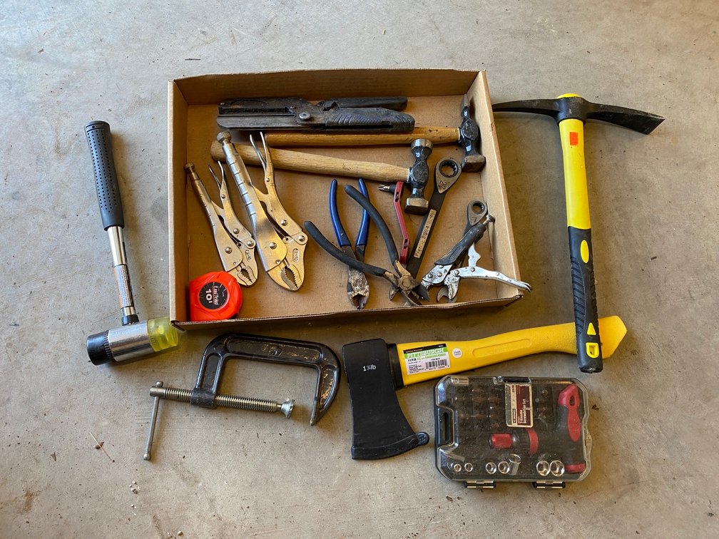 Vise grips, hammer, hatchet, small pick, C-clamp