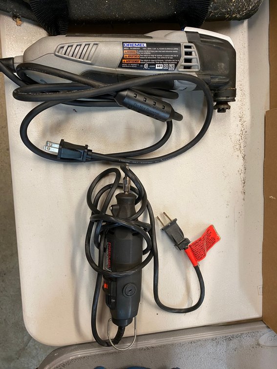 2 Dremel tools with accessories