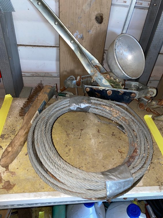 Ratcheting Cable Puller, Steel Cable Coil, Wire Brush, and Metal Ladle