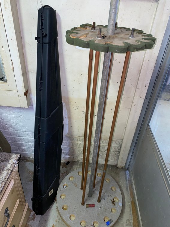 Hard Rifle Case and Freestanding Circular Fishing Pole Rack