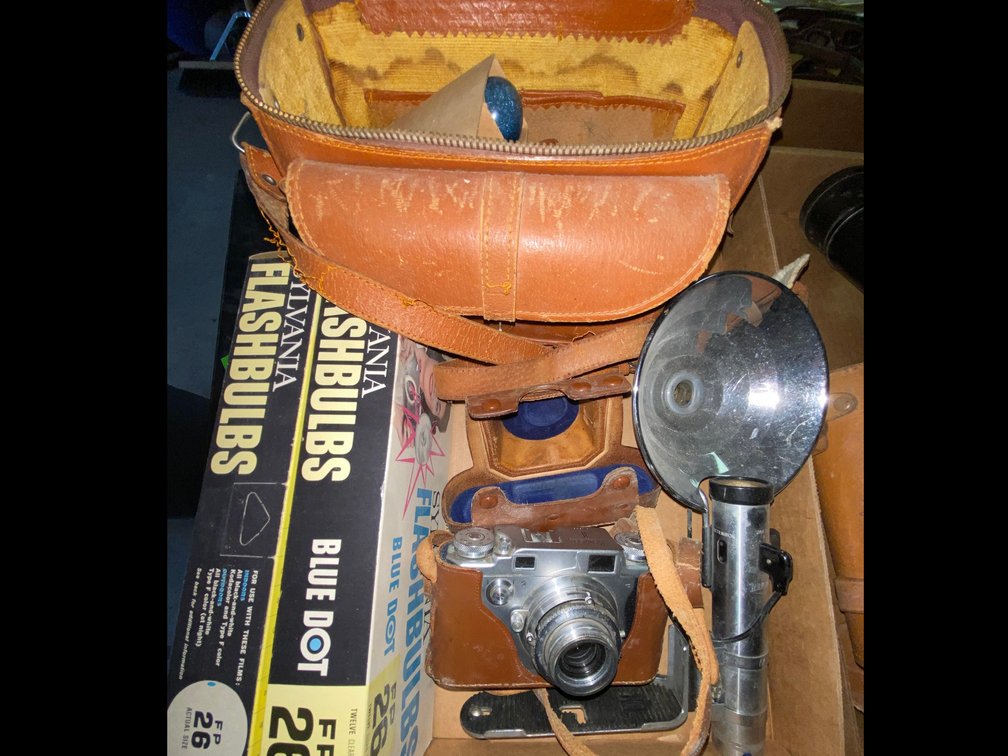35mm Rangefinder Camera, Flash Attachment, Leather Cases, and Flashbulbs