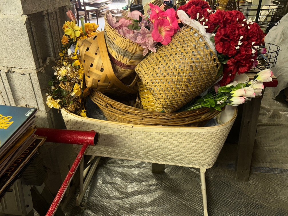 Vintage bassinet with baskets and silk floral items