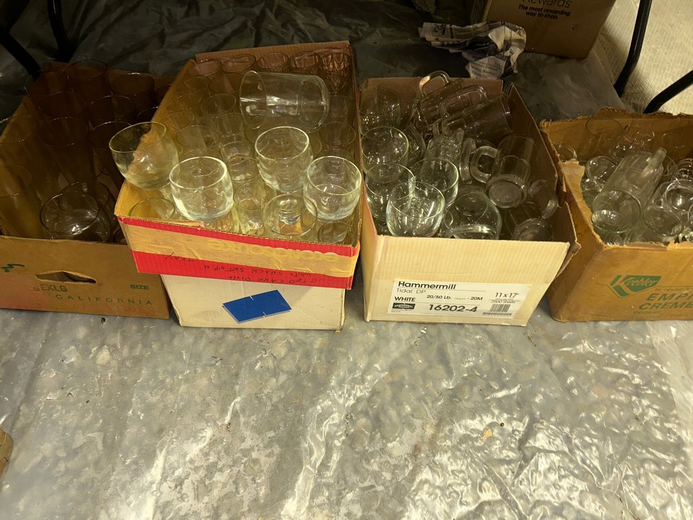 Large collection of clear glass mugs and glasses