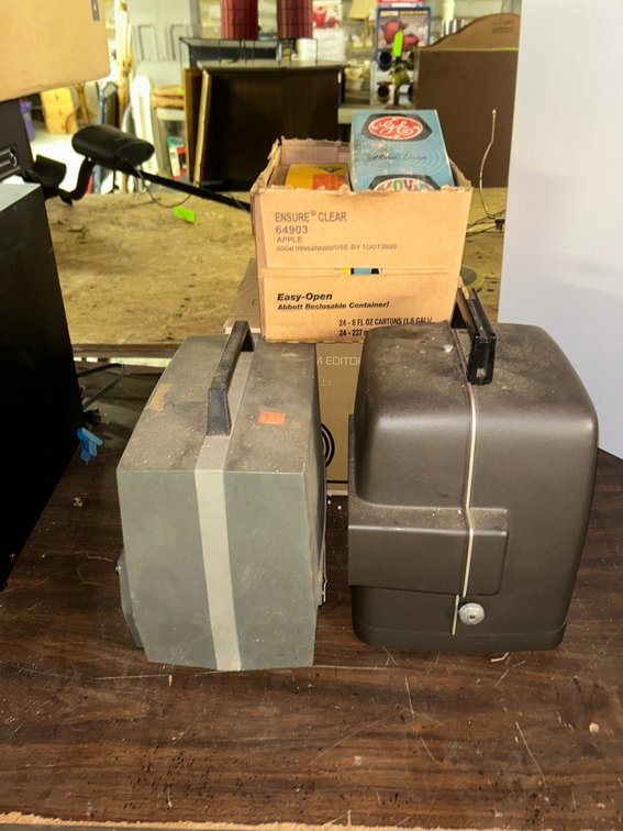 Vintage Bell & Howell movie projector with accessories, movie camera