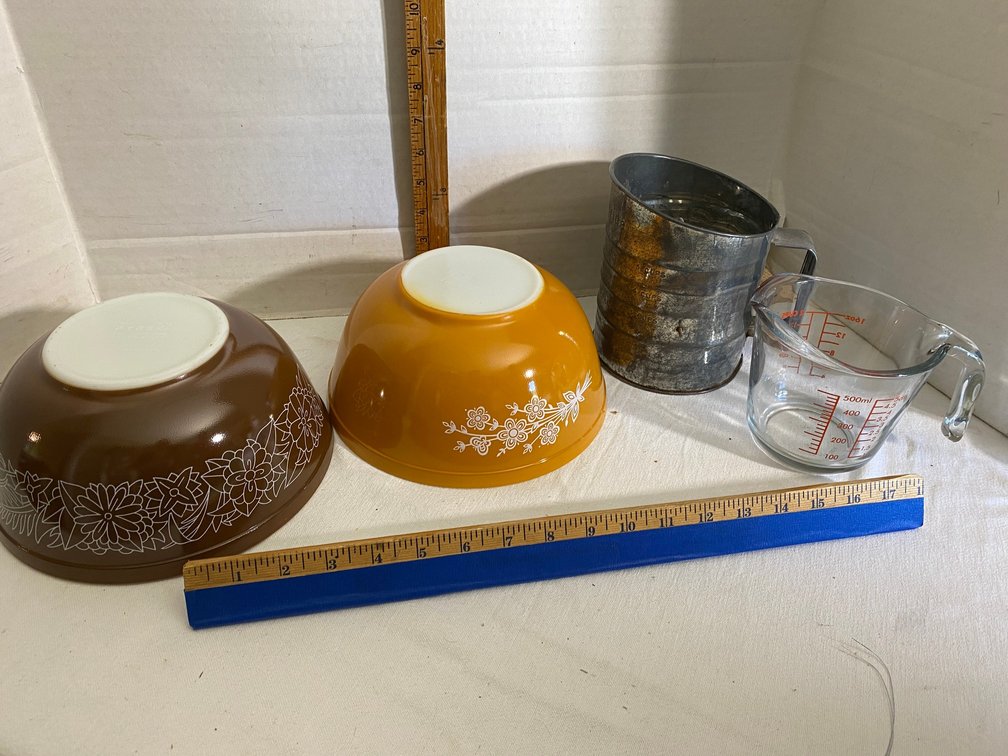 Pyrex bowls-1 is Woodland Brown mixing bowl, other is Butterfly Flower, glass measuring cup, vintage sifter