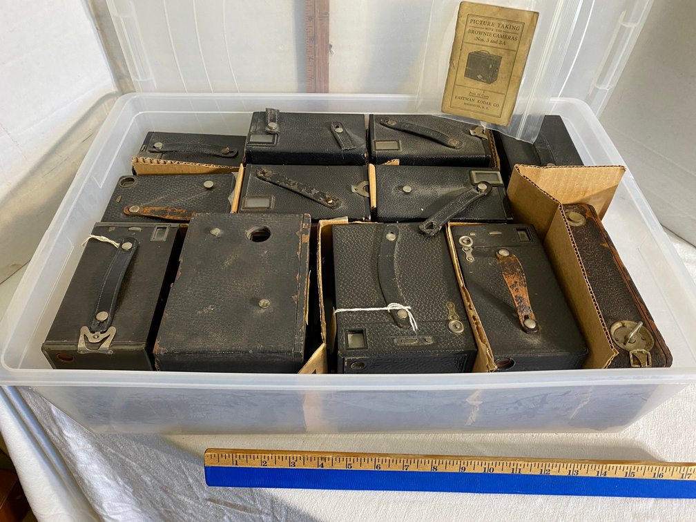 Assortment of vintage box cameras in a tote with lid