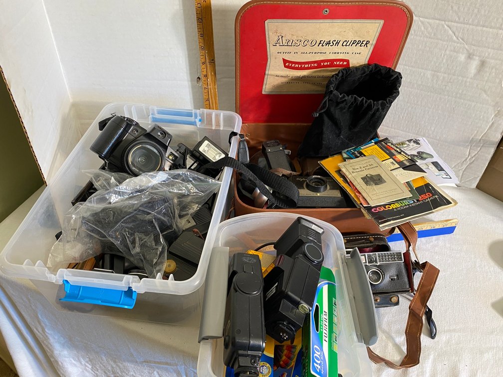 Assortment of cameras, lenses, film, flashes, Instamatic 404, Matsui model 3006, Konica C35, Baby Brownie, and more