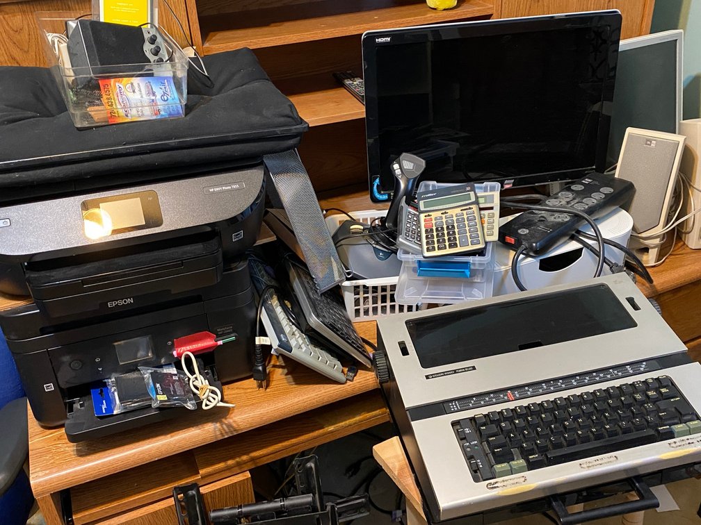 Office supplies, computer monitors, speakers, surge protectors, calculators, Silver Reed typewriter, HP printer, Epson printer
