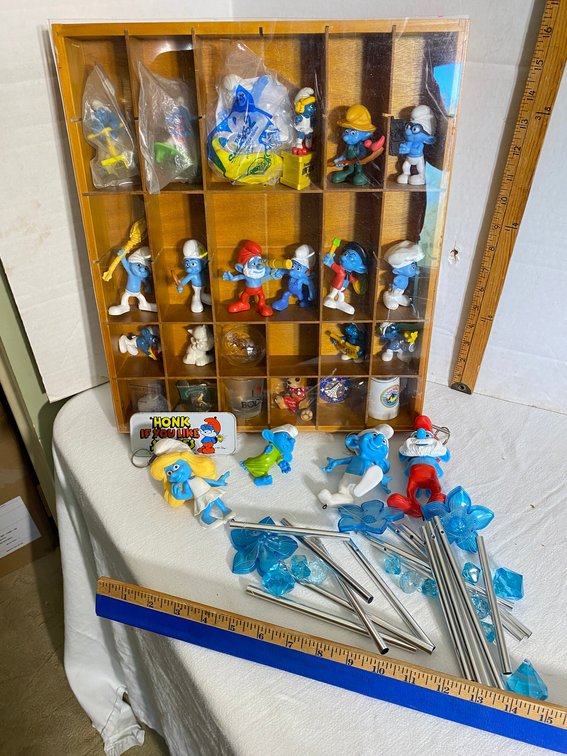 Assortment of collectible Smurf figures, windchimes-in a divided display case