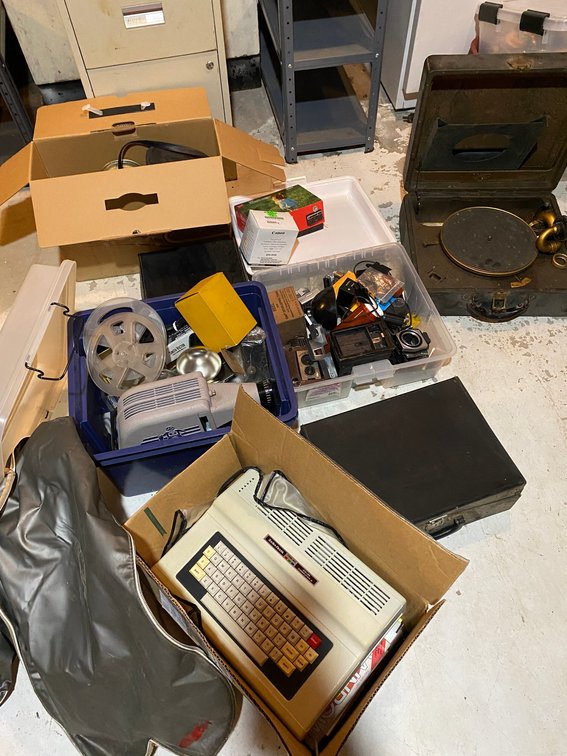 Assortment of vintage cameras and supplies, record player, Radio Shack TRS-80 keyboard