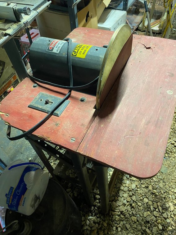 Sander on a metal stand with electric motor