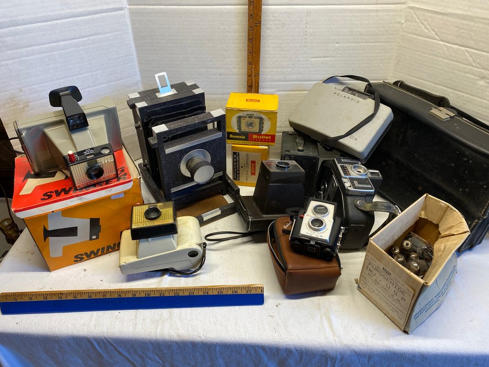 Assortment of early cameras-Polaroid Big Swinger 3000, Polaroid Land camera, Brownie Starflex camera, Polaroid Zip Land camera, Bell & Howell camera and more