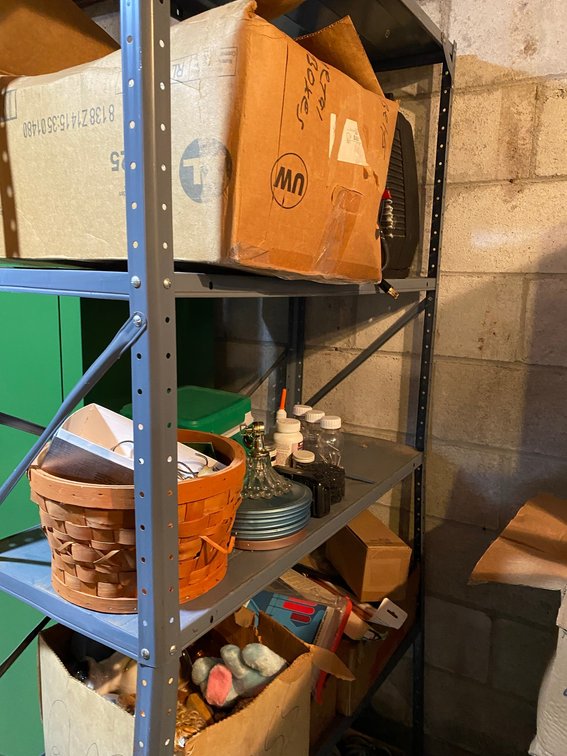 Metal shelf with contents of household items