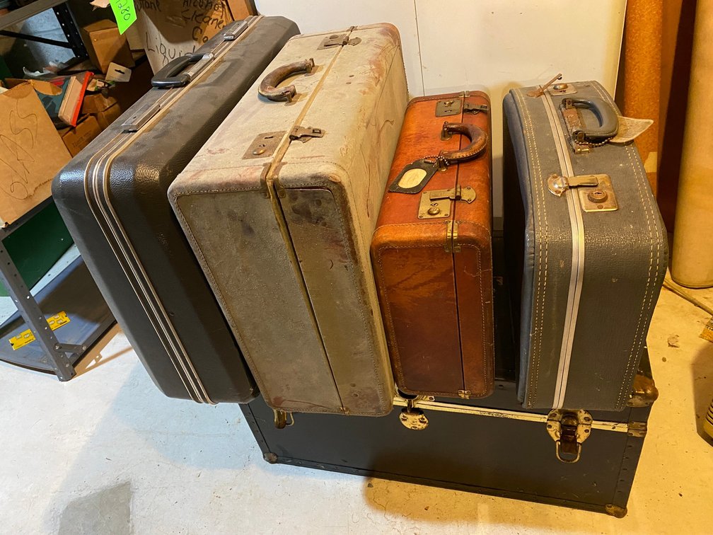 Assortment of vintage suitcases, foot locker