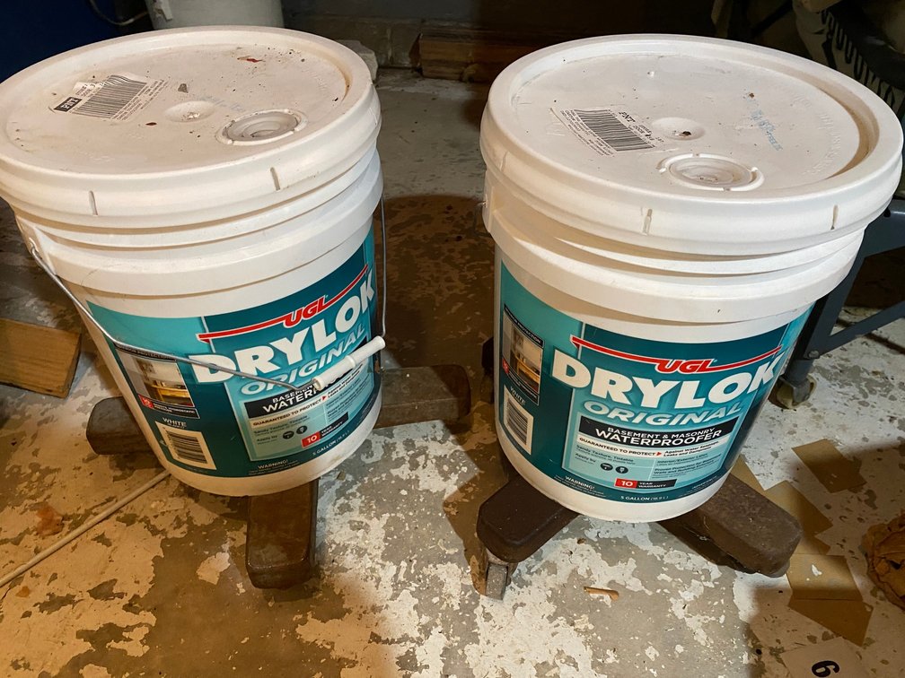 Two 5 gallon buckets of Original DryLok waterproofing-never opened-on rolling cart