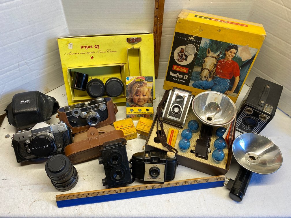 Assortment of cameras-Kodak Duaflex 4 camera with box and flashes, Argus C3 box only, Petri model FT camera, Brownie 127, Argus camera, Brownie Target 616 and more