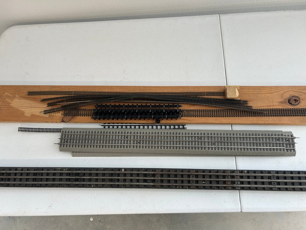 2 Sections of Lionel fast track, 6' section of O27 mounted on board, some N and HO flex track