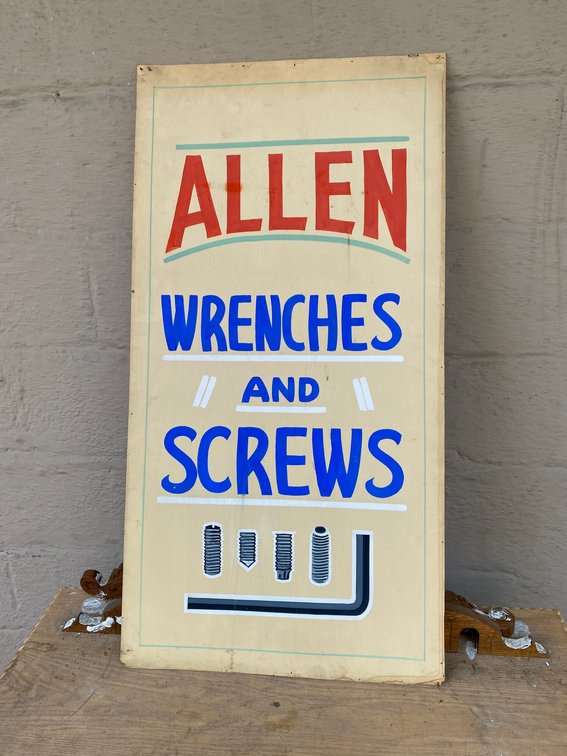 Allen wrenches, screws, cardboard sign