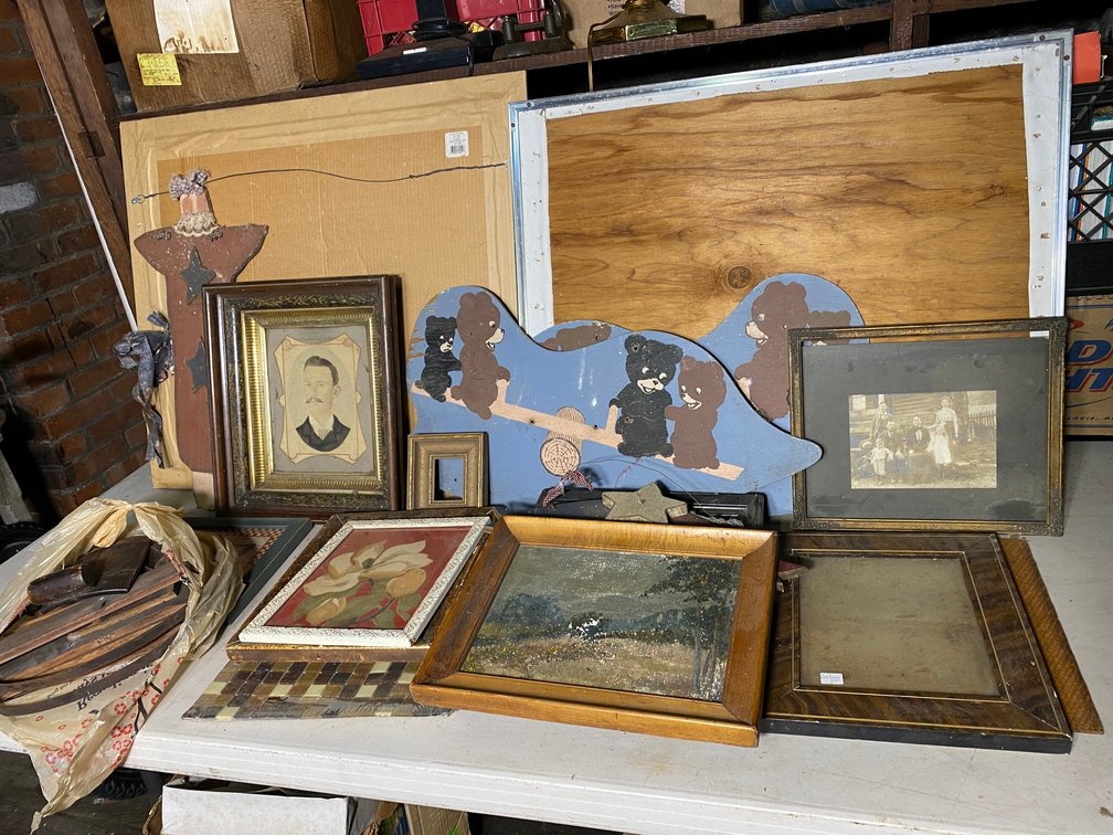 Antique wall hangings, photographs, disassembled wooden bucket