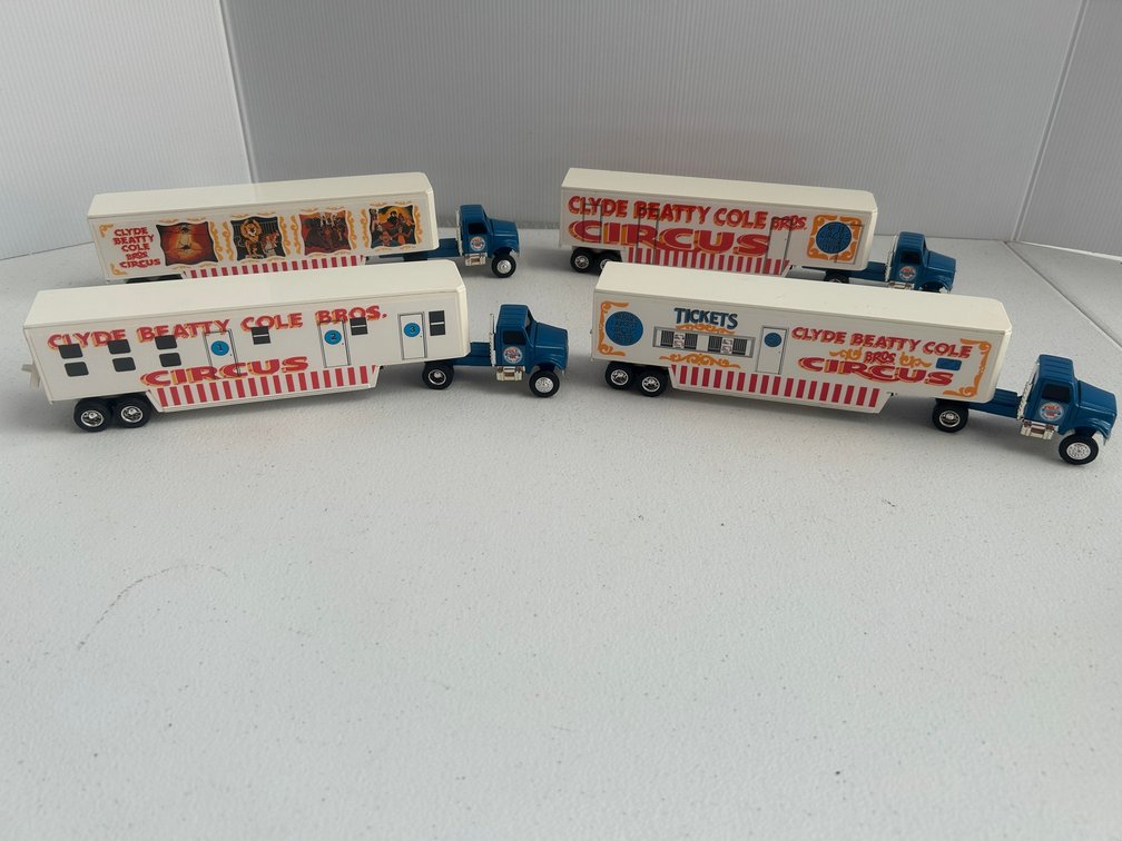 Four 1:48 scale semi-trucks and trailers