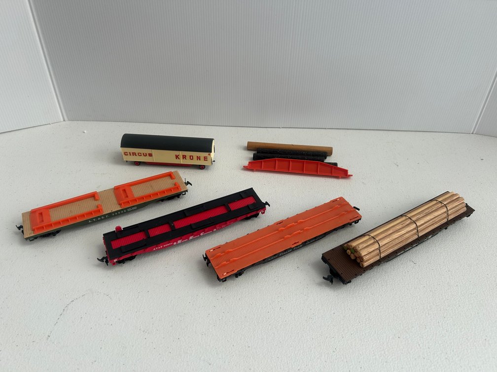 Selection of HO Scale railroad flat cars with Tempos and a wagon