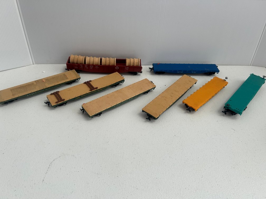 Selection of railroad flat cars, a gondola, various railways