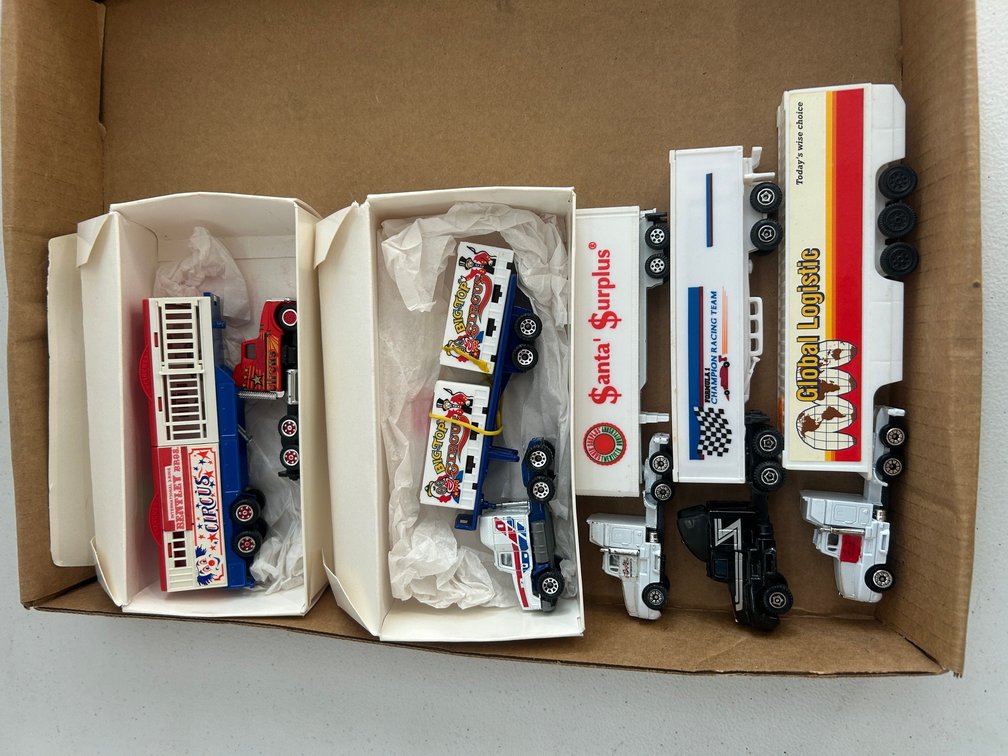 Selection of HO Scale circus theme tractors, trucks and trailers with loads