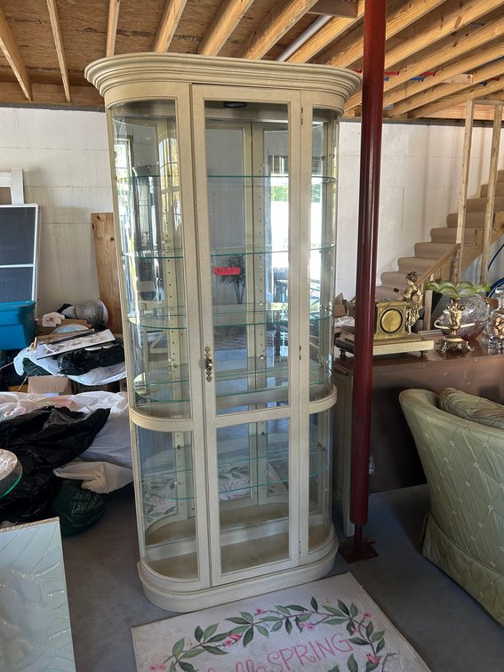 Curved Glass display Cabinet that is Lighted with glass shelves