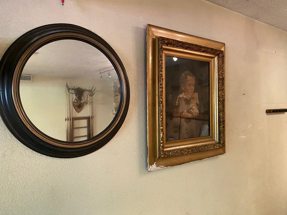 Mirror and a Framed Print of a Small Child