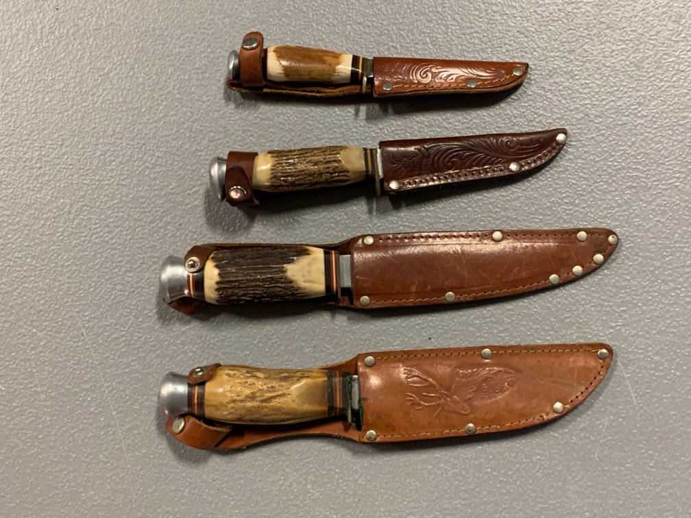 [3117]  Four Fixed Handle Hunting Knives w/Sheaths
