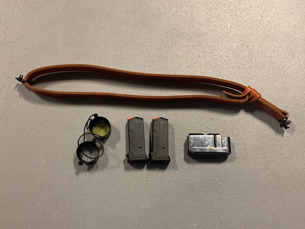[3217]  Remington Rifle Mag, two Handguns Mags, Scope Covers, Leather Sling