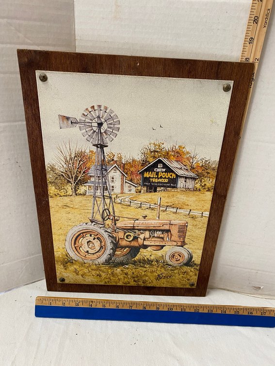 Tin sign with a Mail Pouch Barn and Farm All Tractor