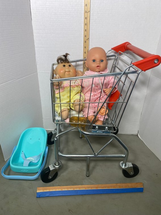 Metal child's grocery cart with dolls