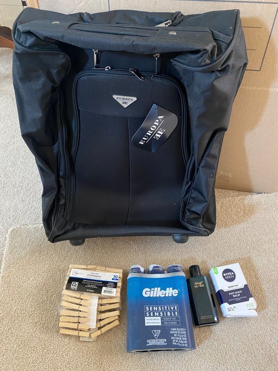 Europa rolling suitcase with Gillette shaving cream, post-shave balm, aftershave, clothespins