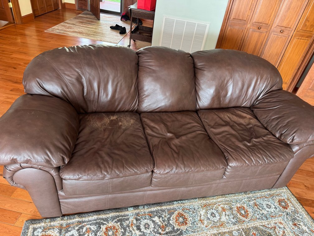 Dark brown 3 cushion leather sofa with high back styling and rolled arms