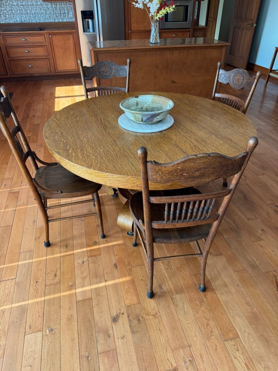 Round wooden dining table with 4 chairs