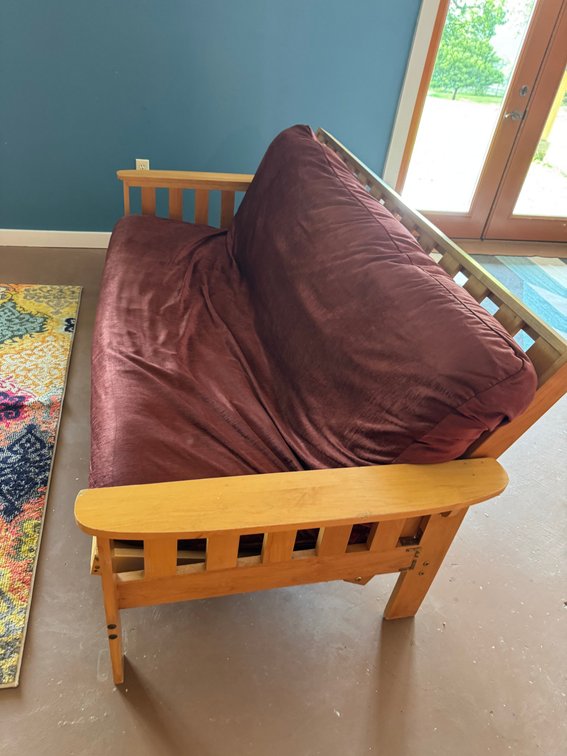Wooden futon with reddish/brown cover