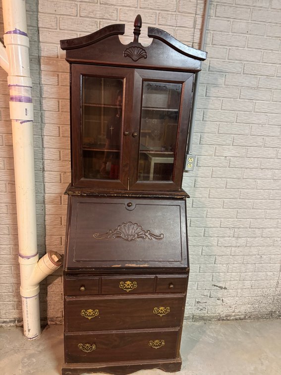 Vintage secretary style desk with dark wood finish and glass cabinet top