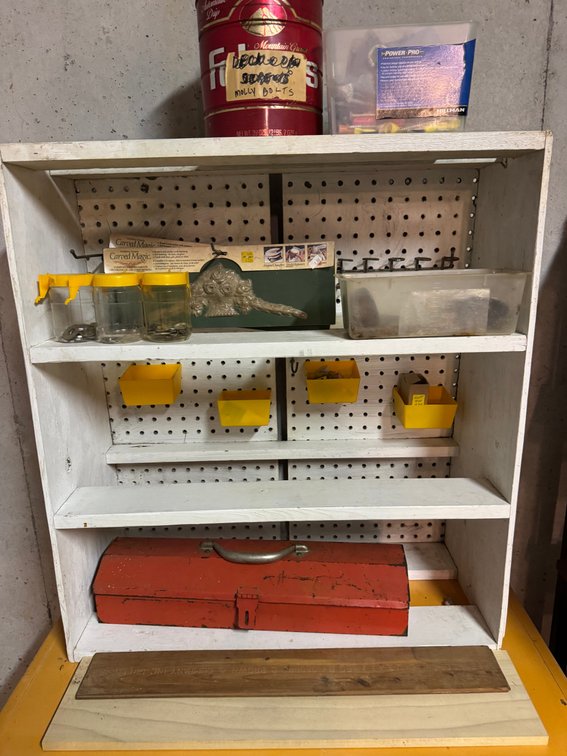 White free standing shelf unit with pegboard backboard