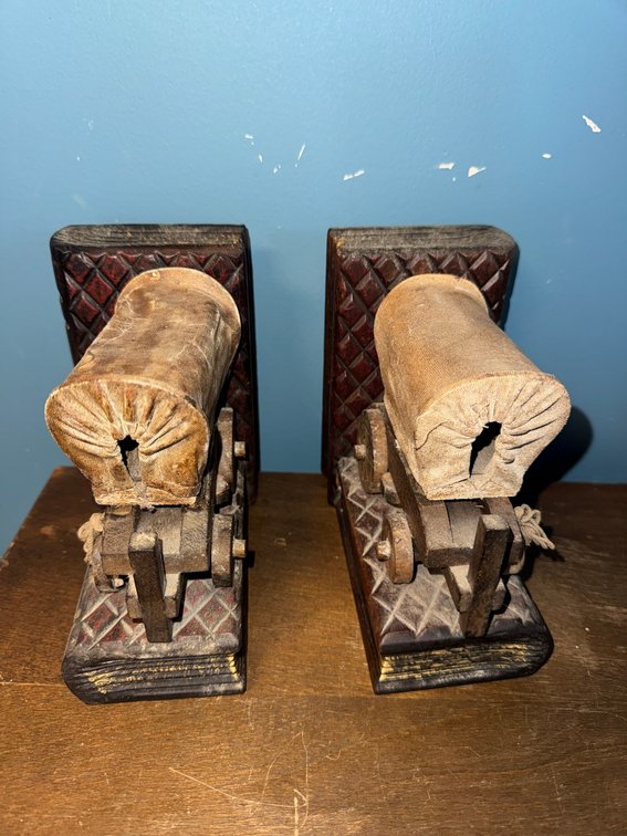 Vintage wooden bookends featuring a covered wagon design